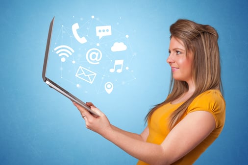 Woman holding laptop with online services symbols