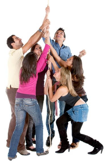 casual friends making an effort to climb up a rope isolated over white