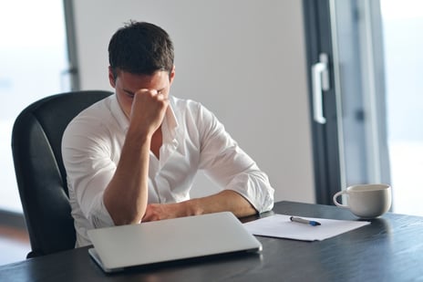 frustrated with problems young business man working on laptop computer at home