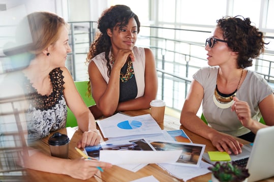 team of successful business people having a meeting in executive sunlit office